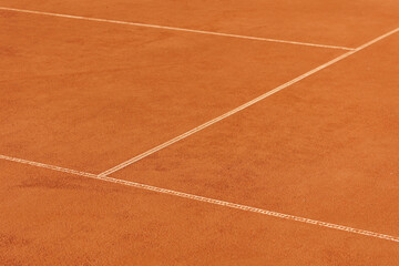 tennis court made of red clay soil with markings for game or competition. sports and recreation, professional performance champions in lawn tennis with rackets and balls. training of athletes outdoor