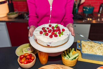 woman serving strawberry cake