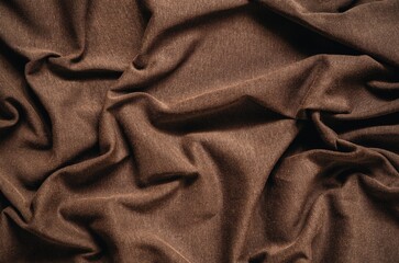 Brown wrinkled fabric texture. Close-up of soft cotton cloth, may be used as background. - 610803778