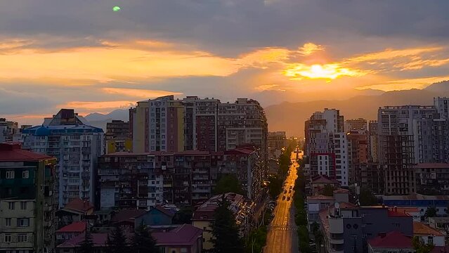 View of the warm dramatic sunset or sunrise sky over the city of Batumi, Georgia. Urban, morning and summer concept