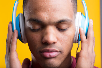 Concentrated man, blue headphones, closed eyes