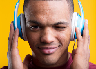 Man winks, listens to music intensely