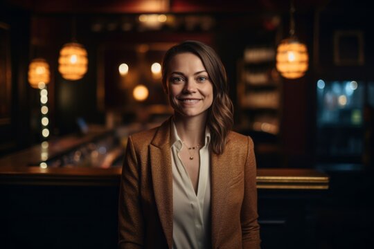 Medium shot portrait photography of a grinning woman in her 30s that is wearing a classic blazer against an atmospheric speakeasy bar with vintage decor background .  Generative AI