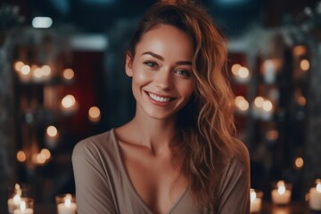 Obraz premium Portrait of a beautiful young woman in a room with candles.