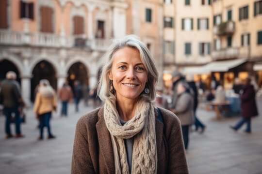 Portrait of smiling middle-aged woman in the street of Venice, Italy