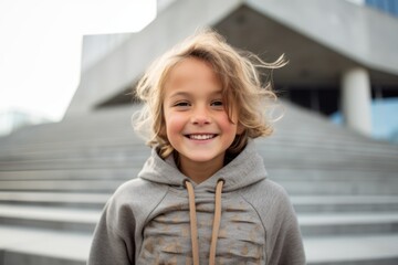 Portrait of a cute little girl with blond hair in the city