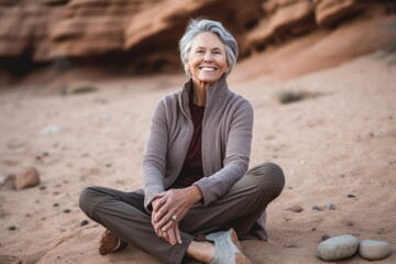 Fototapeta na wymiar Medium shot portrait photography of a pleased woman in her 50s that is wearing a cozy sweater against a zen rock garden with raked sand background . Generative AI