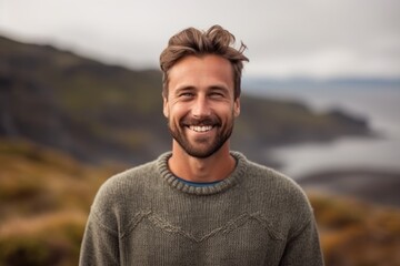 Portrait of handsome man smiling at camera on a foggy day