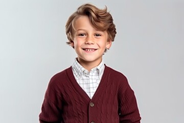Medium shot portrait photography of a pleased child male that is wearing a chic cardigan against a white background .  Generative AI