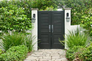 black louvered double doors to the formal gardens