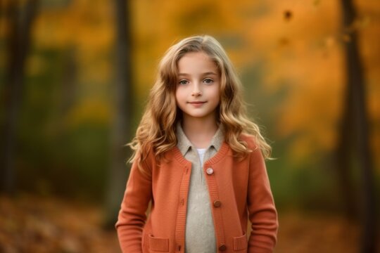 Medium shot portrait photography of a satisfied child female that is wearing a chic cardigan against a brilliant display of fall foliage in a forest background .  Generative AI