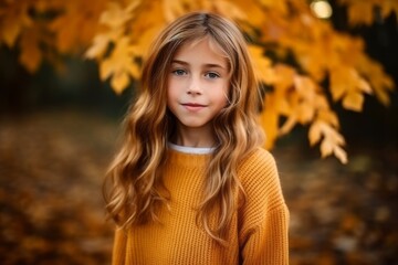 Fototapeta premium Portrait of a beautiful little girl in a yellow sweater in the autumn forest.