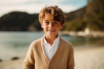 Portrait of cute little boy on the beach at sunset time.
