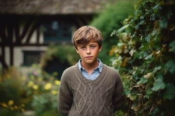 Fototapeta premium Portrait of a cute boy in the countryside. Selective focus.