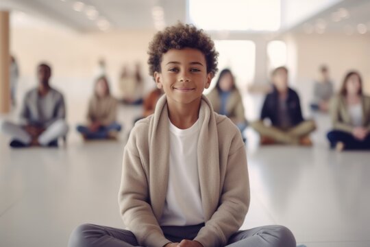 Medium shot portrait photography of a satisfied child male that is wearing a chic cardigan against a serene yoga class setting with participants practicing background .  Generative AI