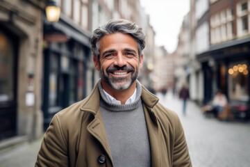 Fototapeta premium Medium shot portrait photography of a pleased man in his 40s that is wearing a chic cardigan against a charming european cobblestone street with cafes background . Generative AI