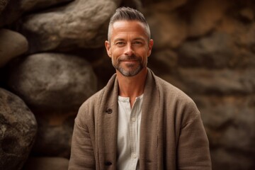 Medium shot portrait photography of a pleased man in his 40s that is wearing a chic cardigan against a zen rock garden with raked sand background .  Generative AI
