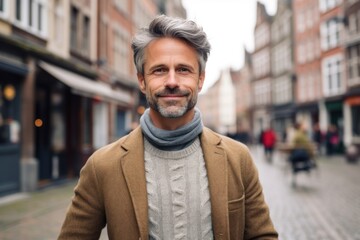 Fototapeta na wymiar Portrait of handsome middle-aged man in a city street.