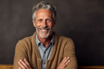 Obraz premium Medium shot portrait photography of a pleased man in his 50s that is wearing a chic cardigan against a paper or textured background . Generative AI