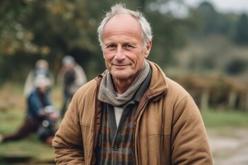 Portrait of a senior man with grey hair in the countryside.