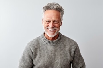 Obraz premium Portrait of a happy senior man smiling at camera isolated over white background