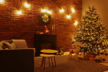 Beautiful tree with festive lights and Christmas decor in living room. Interior design
