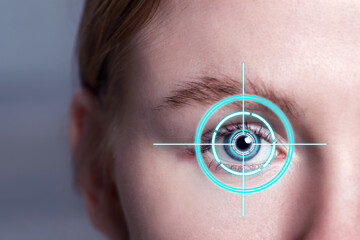 Vision test. Laser reticle focused on woman's eye, closeup