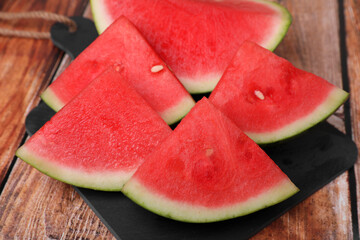 Pieces of juicy ripe watermelon on wooden table, closeup