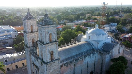 Aerial closeup with sun behind of the Cathedral de San Gervasio just after sunrise in Valladolid, Yucatan, Mexico.