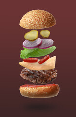 Delicious burger with different flying ingredients on color background