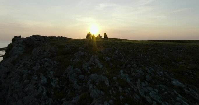 Parents And Children Watching The Setting Sun On A Stunning Coastal View