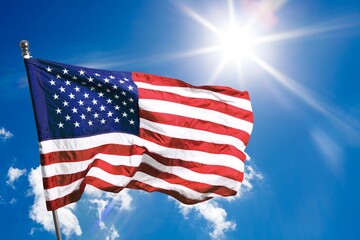 American USA flag waving on sky background.