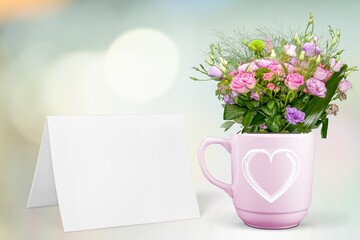 Mug with a pink heart, fresh flowers bouquet