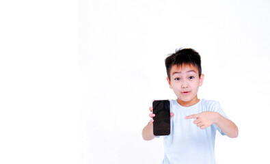 a little boy in a blue T-shirt points with his index finger at the smartphone screen. layout and layout. space for text and pictures.