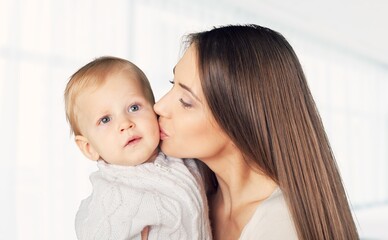 Happy beautiful young mother holding newborn baby