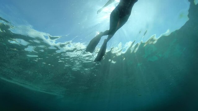 Scuba diving, swimming and woman diver in ocean for adventure, holiday and vacation in Mauritius. Nature, travel and female person in tropical water to explore coral reef and snorkeling on island