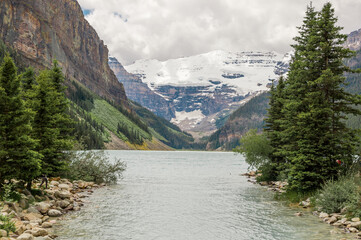 Lake Louise, Banff National Park, Alberta, Canada. Blurred background. Rocky Mountain lake landscape panorama without people - forest, scenic blue lake. 