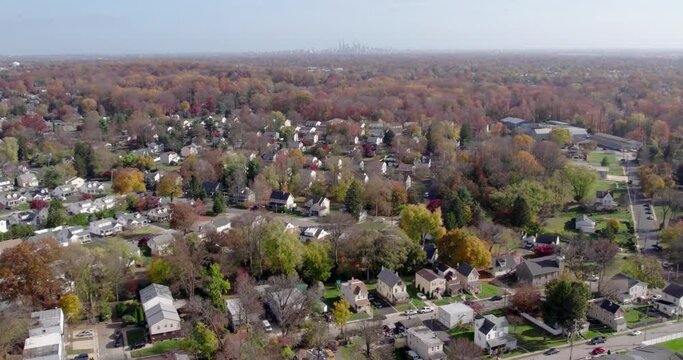 Drone Soaring over Springfield, PA, Revealing Hazy Philadelphia Skyline in Fall Suburban Charm in Montgomery County
