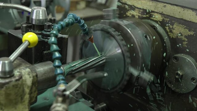 Engineering an alloy sprocket through a reaming process on a lathe machine with great precision.