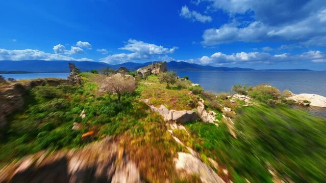 FPV drone flies over the ruins of the ancient city Herakleia .Latmos , Bafa lake. 4K