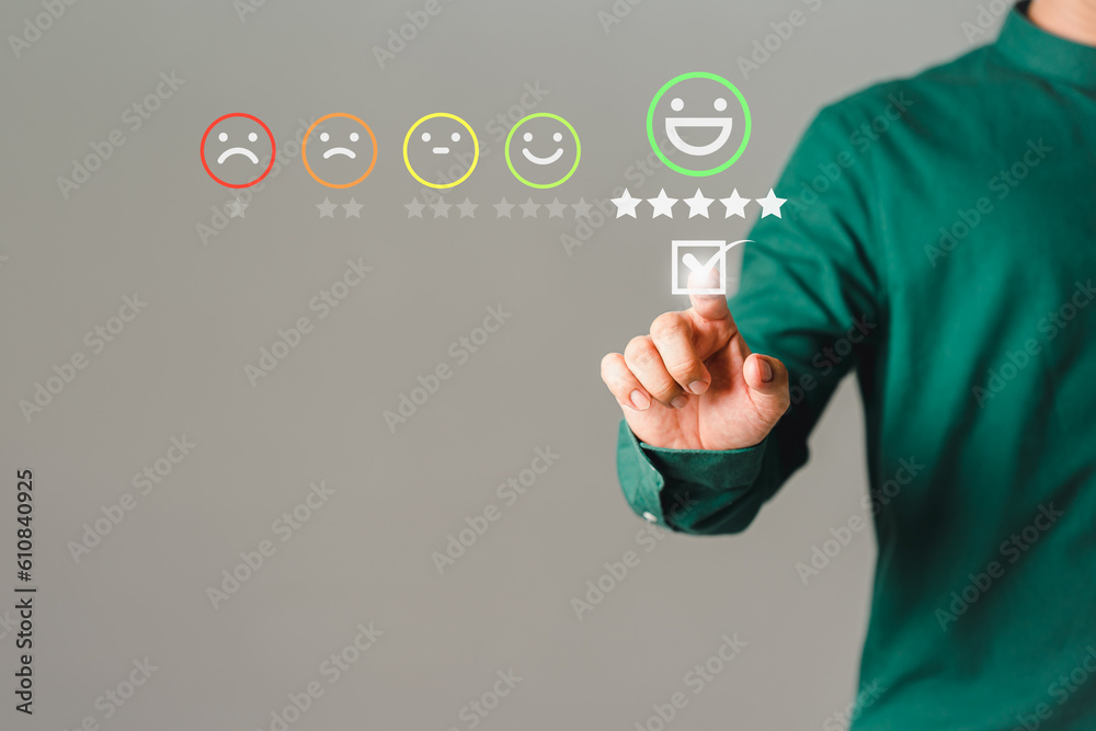 Poster customer's hand is touching virtual screen on the happy smile face icon to give satisfaction in serv