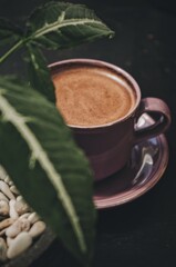 A cup of coffee to start the day with the warm rays of the morning sun, brewed using the Indonesian brewing method "Tubruk". plants and silhouettes
