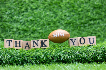 American Football with Thank you on green grass