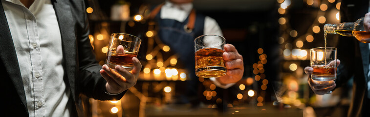 Barman pouring whiskey whiskey glass celebrate whiskey on a friendly party in  restaurant