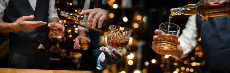  Barman pouring whiskey whiskey glass celebrate whiskey on a friendly party in  restaurant