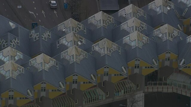 Aerial zoom-out shot of abstract cube houses within Rotterdam city centre, Netherlands