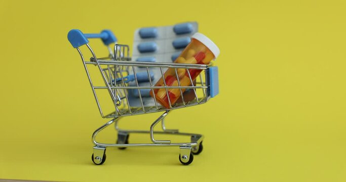 Person puts medical pills in shopping cart. Purchase of medicines