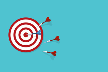 Red darts missed hitting target and only blue one hits the center. Business challenge failure and success concept.