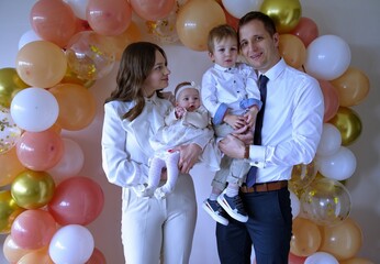 Young family celebrating christening of little baby girl