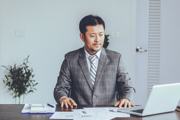 Asian businessman working with laptop at office